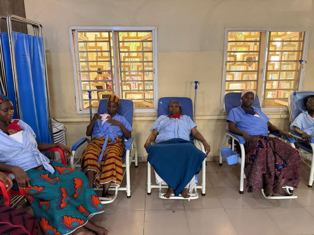 Mothers in Kangaroo Care chairs along the ward, their newborns against their chests