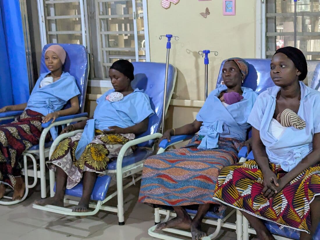 Four mothers in Kangaroo Care chairs, each with her newborn against her chest