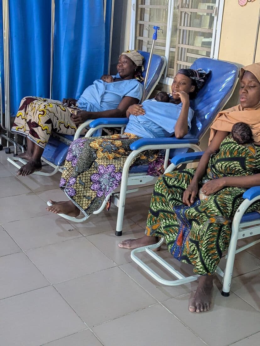 Two mothers in neighbouring Kangaroo Care chairs, each with a newborn against her chest