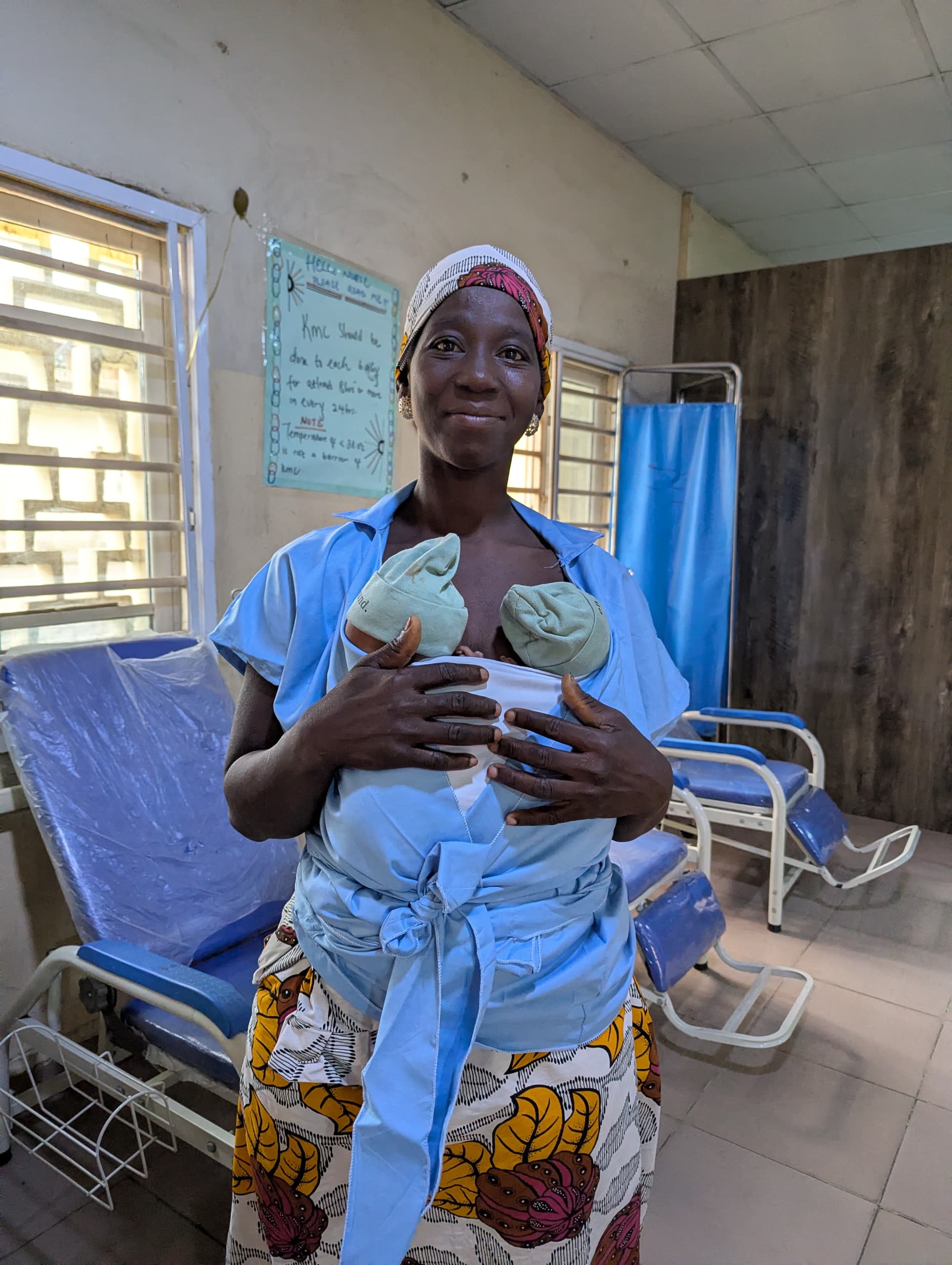 A mother on the Kangaroo Care ward in Kano holding her twins skin-to-skin